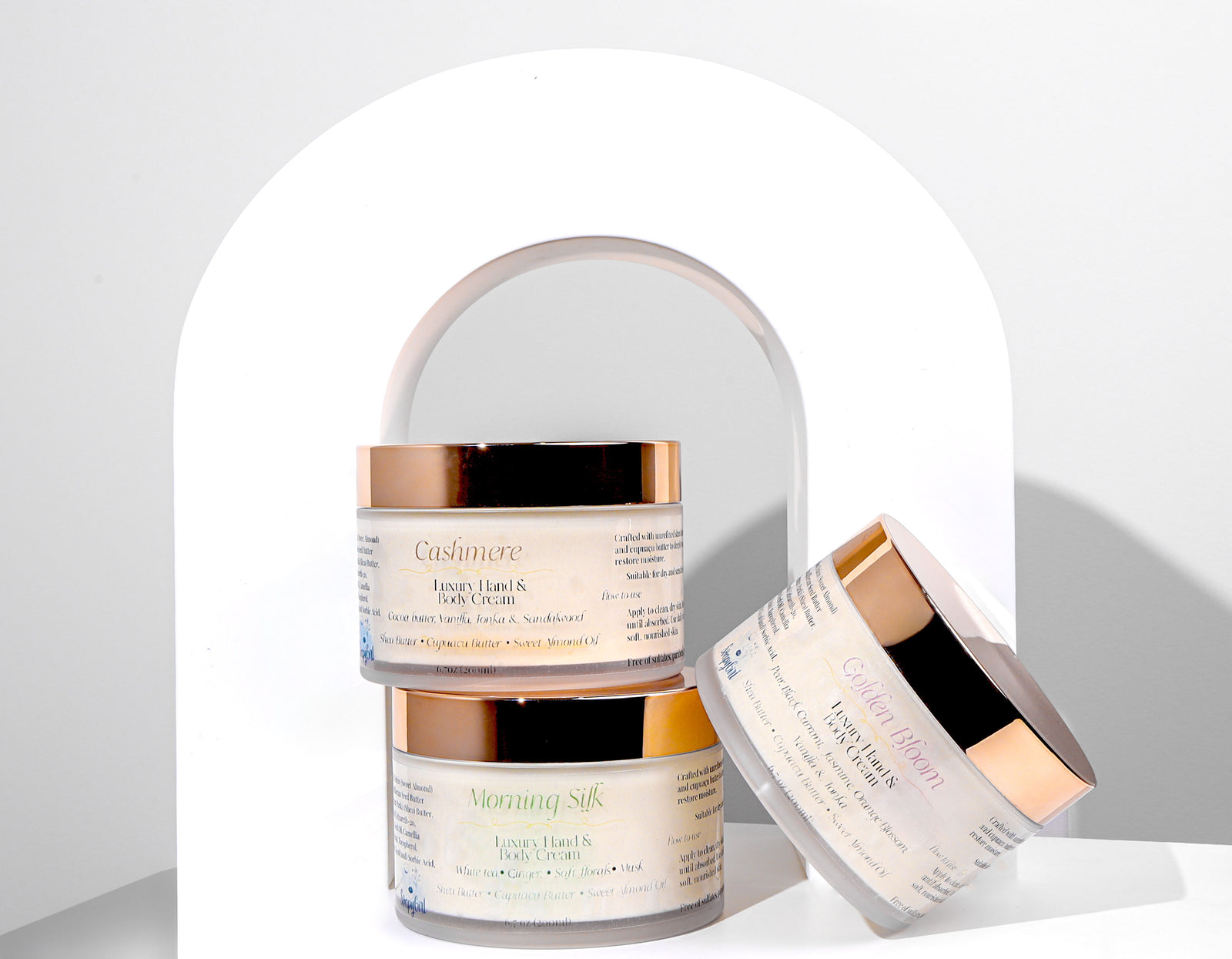 Three jars of body cream on a white background
