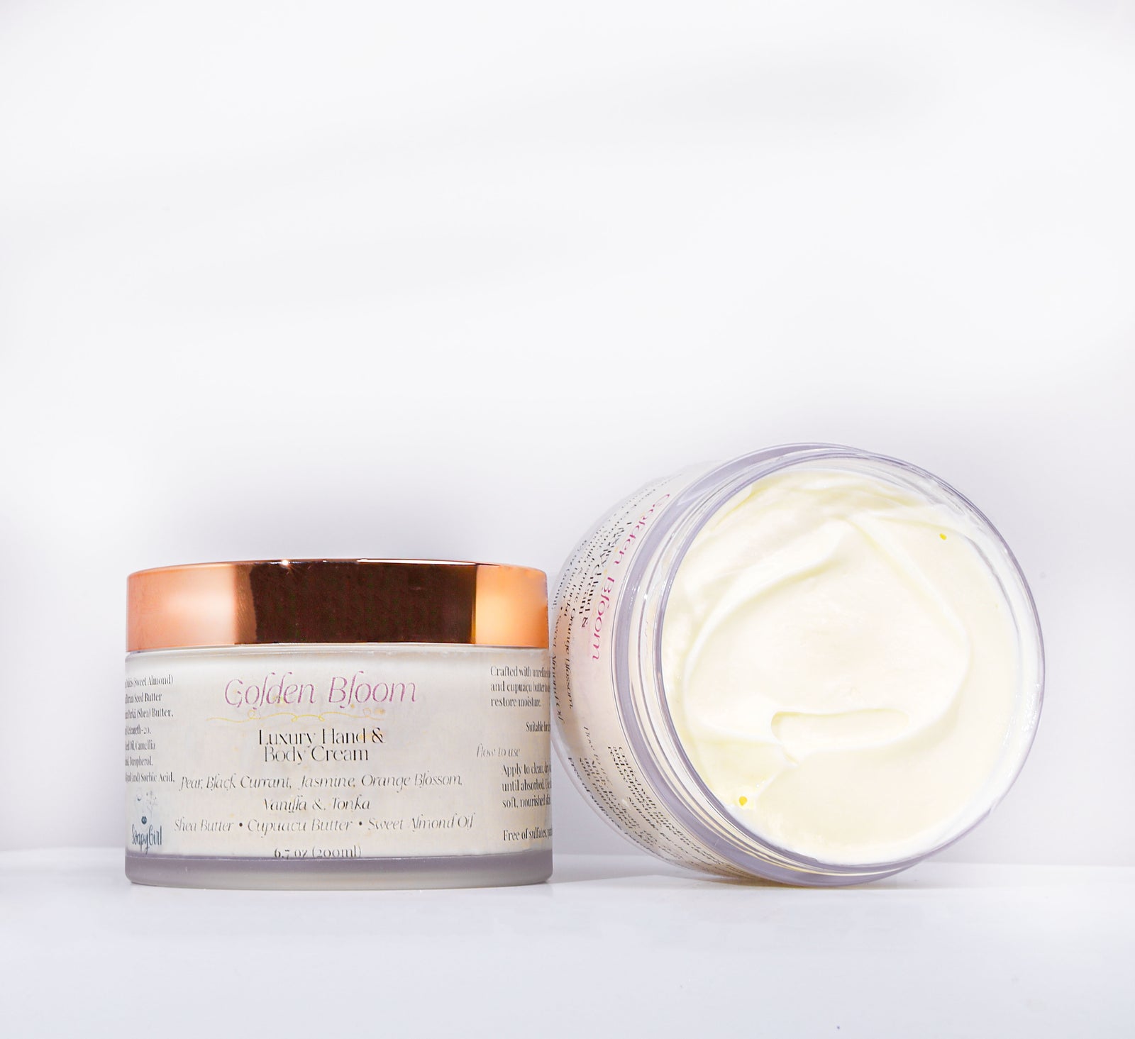 Two jars of Golden Bloom cream on a white background