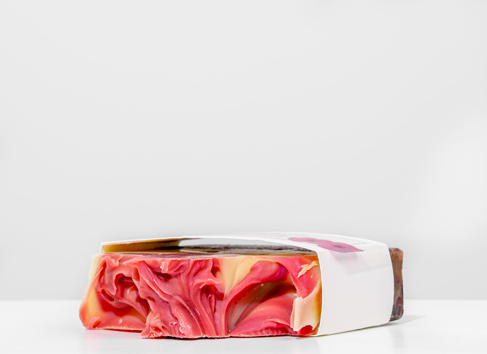 Handmade soap bar with a label on a white background